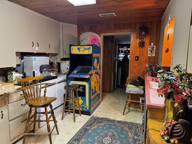 kitchen with wood walls and wooden ceiling