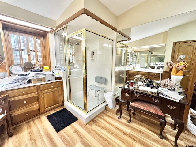 1115 Sunset Ave, Jacksonville, TX 75766 - full bathroom with a shower stall, wood finished floors, vanity, and vaulted ceiling