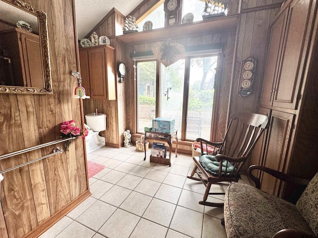 1115 Sunset Ave, Jacksonville, TX 75766 - bathroom with vaulted ceiling, wood walls, tile patterned flooring, and a textured ceiling