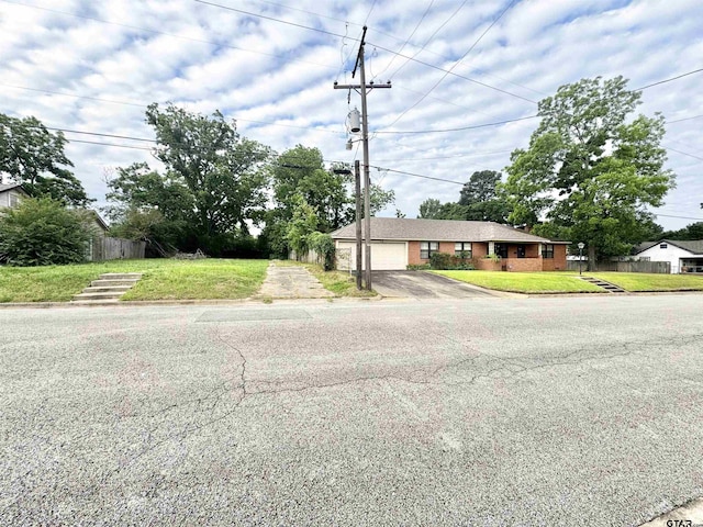 1115 Sunset Ave, Jacksonville, TX 75766 - view of front of property featuring asphalt driveway and an attached garage
