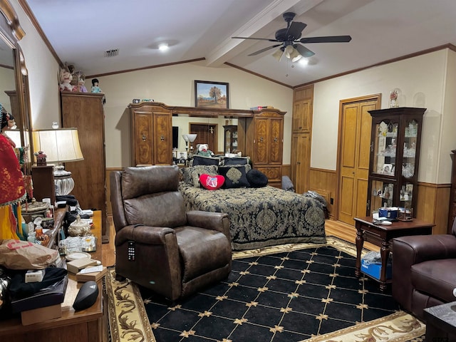 bedroom with ceiling fan, wooden walls, lofted ceiling with beams, and ornamental molding