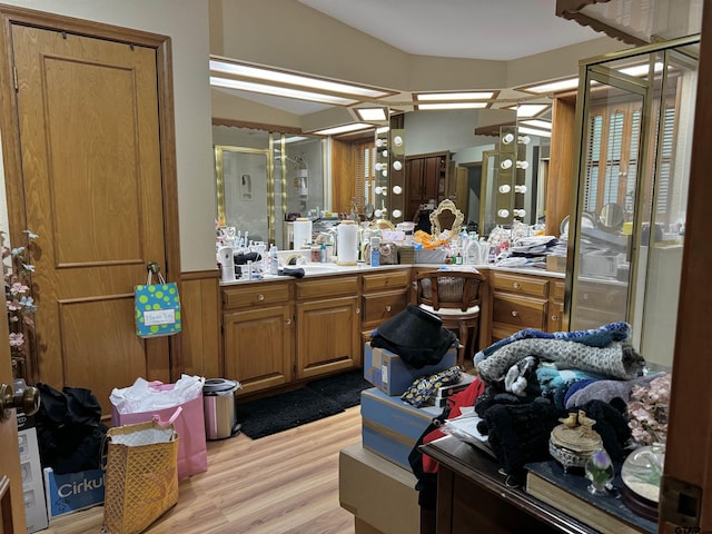 bathroom with vanity, hardwood / wood-style flooring, and a shower with shower door