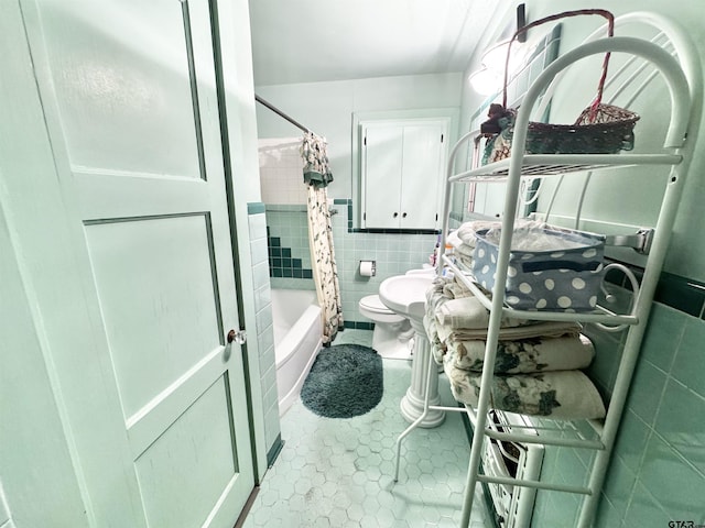 1115 Sunset Ave, Jacksonville, TX 75766 - bathroom with tile walls, toilet, tile patterned flooring, and shower / bath combo with shower curtain