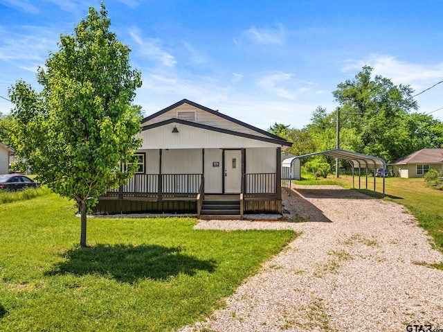 924 Kaufman St, Mount Vernon, TX 75457 - view of front of home with a detached carport, driveway, and a front yard