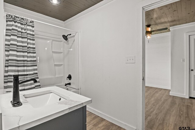 924 Kaufman St, Mount Vernon, TX 75457 - bathroom with wood ceiling, wood finished floors, a sink, and baseboards
