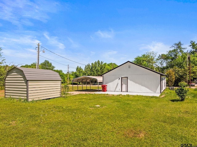 924 Kaufman St, Mount Vernon, TX 75457 - view of yard with an outdoor structure, driveway, and a detached carport