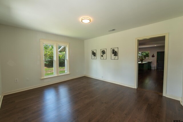 empty room featuring dark wood-type flooring