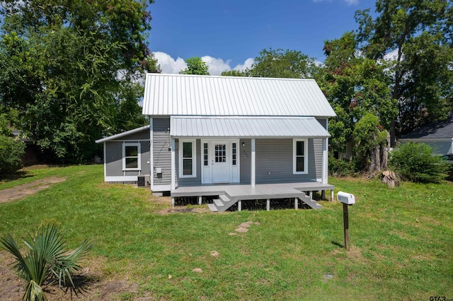 rear view of property with a yard