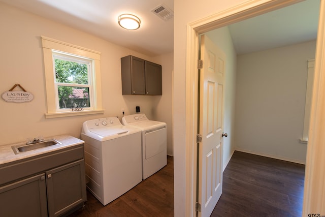 laundry area featuring washer and clothes dryer, cabinets, sink, and dark hardwood / wood-style floors