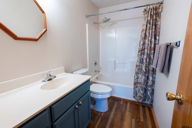 full bathroom with shower / bath combo with shower curtain, vanity, wood-type flooring, and toilet