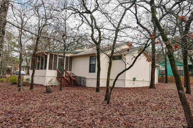 view of property exterior featuring a sunroom