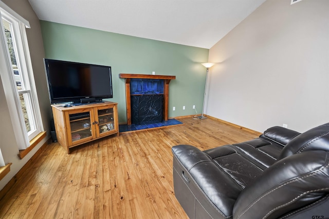 living room featuring hardwood / wood-style floors and vaulted ceiling