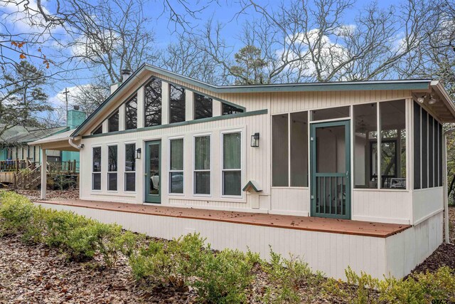 rear view of house with a sunroom