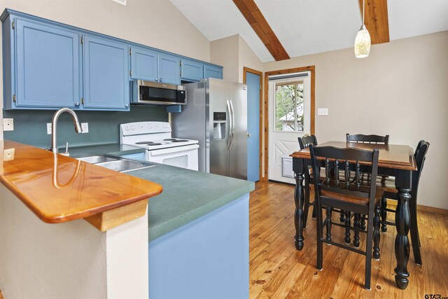 kitchen with kitchen peninsula, appliances with stainless steel finishes, blue cabinets, vaulted ceiling with beams, and hanging light fixtures