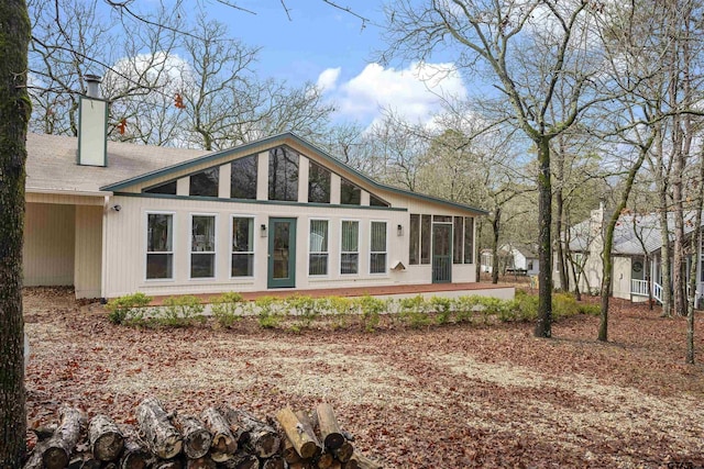 back of house featuring a sunroom