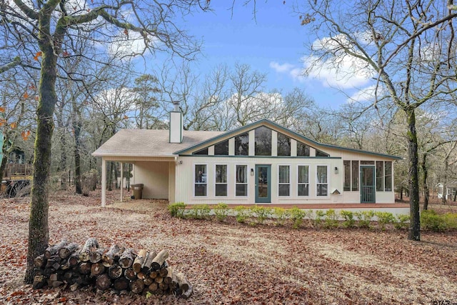 back of property with a sunroom