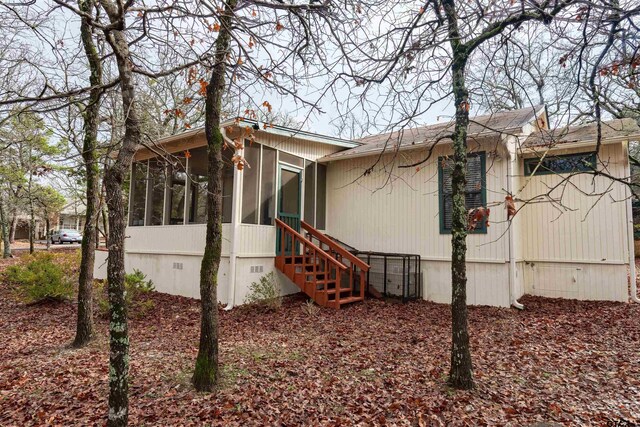 view of side of property with a sunroom