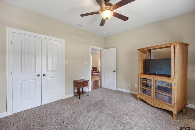 carpeted bedroom with baseboards, ceiling fan, a closet, and visible vents