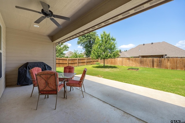 view of patio with outdoor dining area, a fenced backyard, and ceiling fan