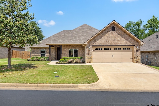 view of front of home featuring a garage, a front lawn, fence, brick siding, and concrete driveway