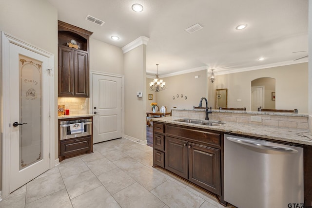 kitchen with stainless steel dishwasher, a sink, dark brown cabinetry, and visible vents