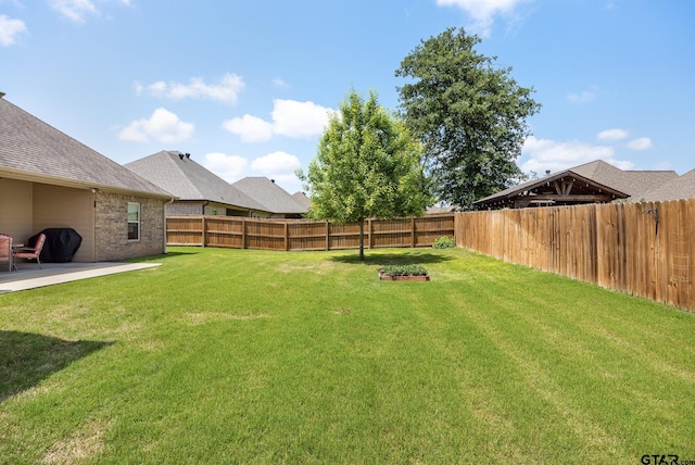 view of yard with a fenced backyard and a patio area