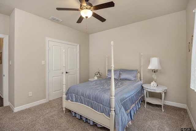 bedroom with baseboards, visible vents, ceiling fan, and carpet