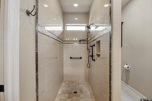 full bath featuring a tile shower
