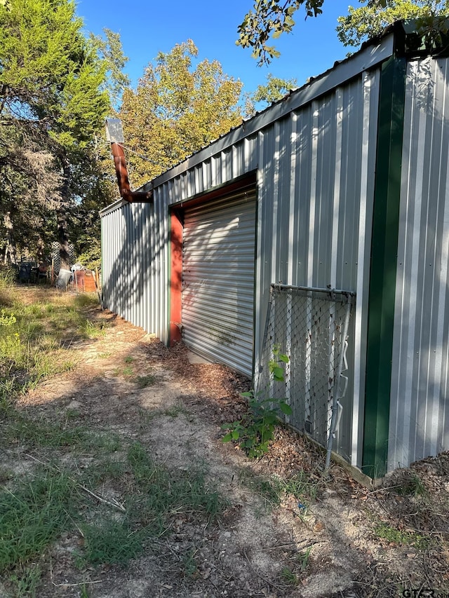 view of home's exterior with an outbuilding and a garage