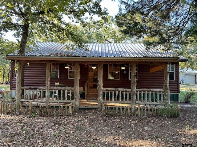 cabin with a garage and covered porch