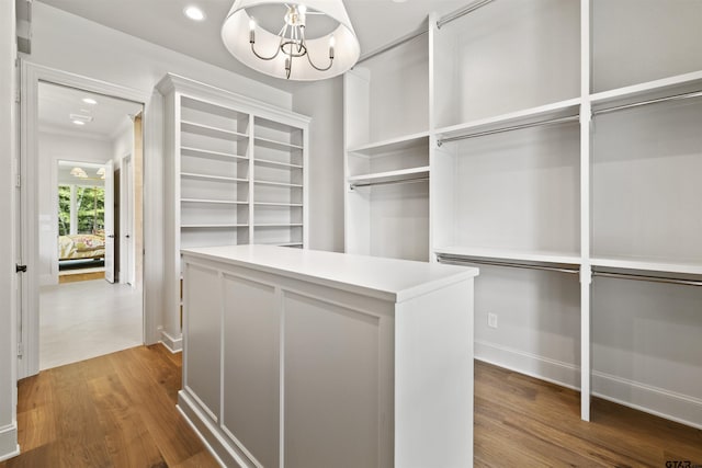 8810 Wilder Trl, Tyler, TX 75703 - walk in closet with a chandelier and wood finished floors