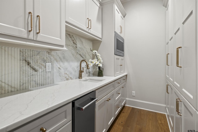 8810 Wilder Trl, Tyler, TX 75703 - kitchen with appliances with stainless steel finishes, dark wood-style flooring, backsplash, white cabinetry, and light stone counters