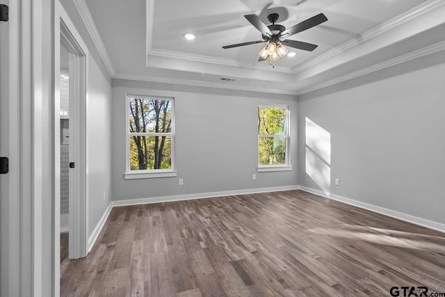 unfurnished room featuring hardwood / wood-style floors, a healthy amount of sunlight, and crown molding