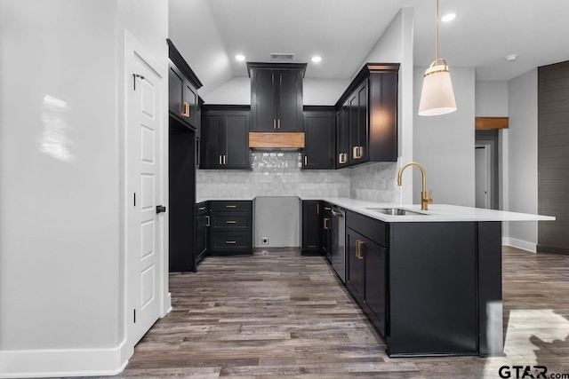 kitchen featuring dishwasher, sink, dark wood-type flooring, tasteful backsplash, and decorative light fixtures