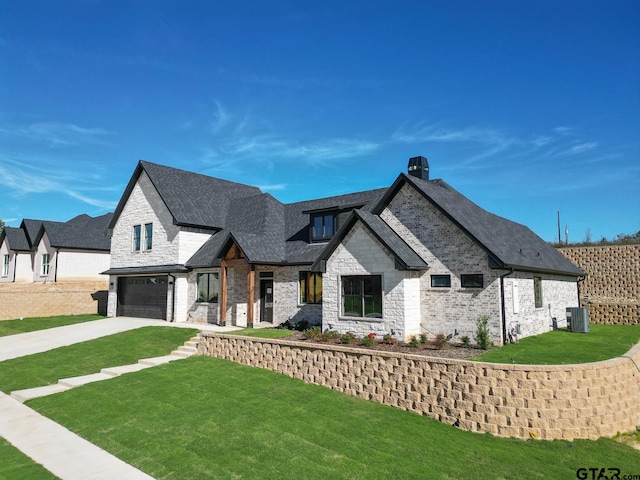 french country home featuring a garage, cooling unit, and a front lawn