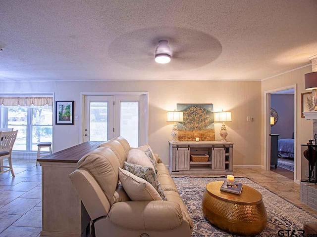 living room with a textured ceiling and light tile patterned flooring