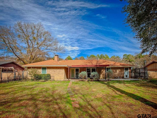 back of property featuring a yard