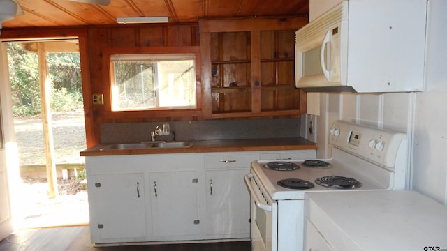 kitchen featuring wood ceiling, white cabinets, a sink, and white appliances