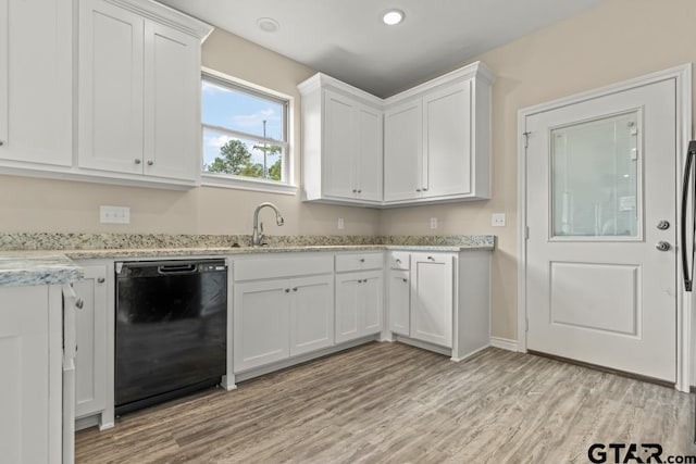 kitchen featuring black dishwasher, light hardwood / wood-style floors, white cabinets, and sink