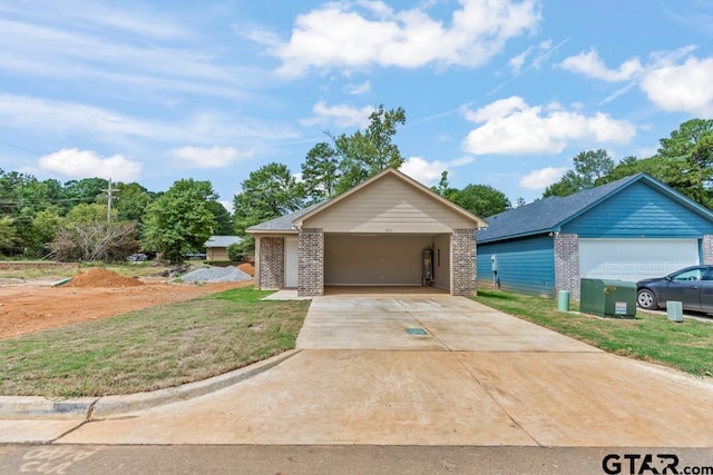 view of front of home with a garage and a front lawn