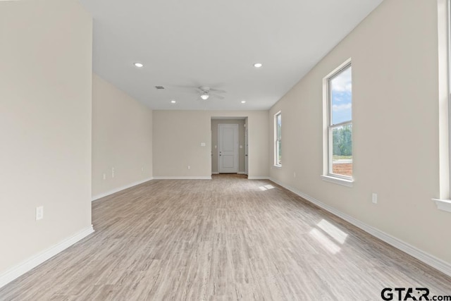 unfurnished room featuring ceiling fan and light wood-type flooring