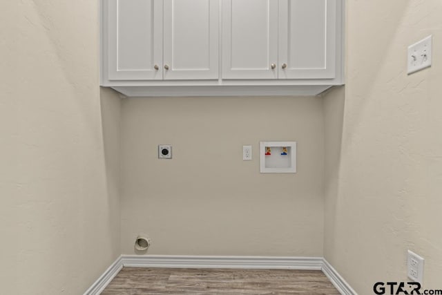 laundry area with cabinets, washer hookup, wood-type flooring, and hookup for an electric dryer