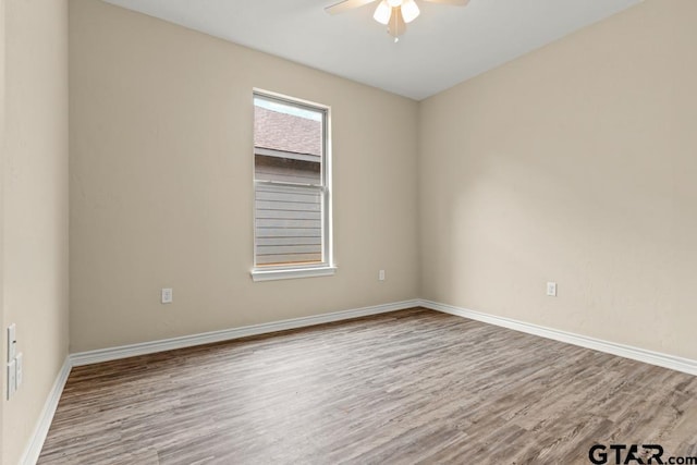 spare room featuring light hardwood / wood-style floors and ceiling fan