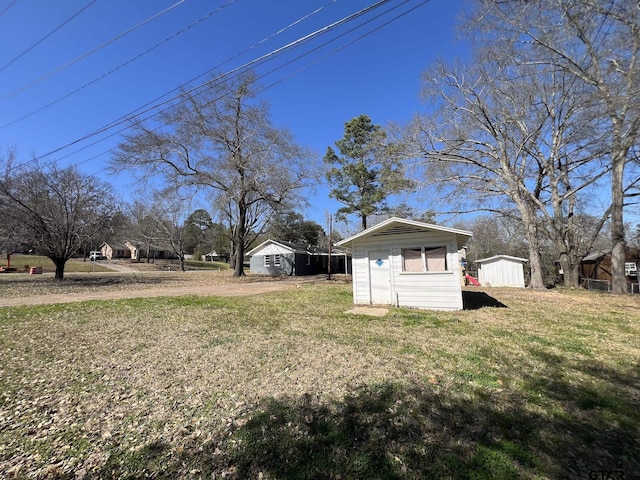 view of yard featuring a storage shed and an outdoor structure