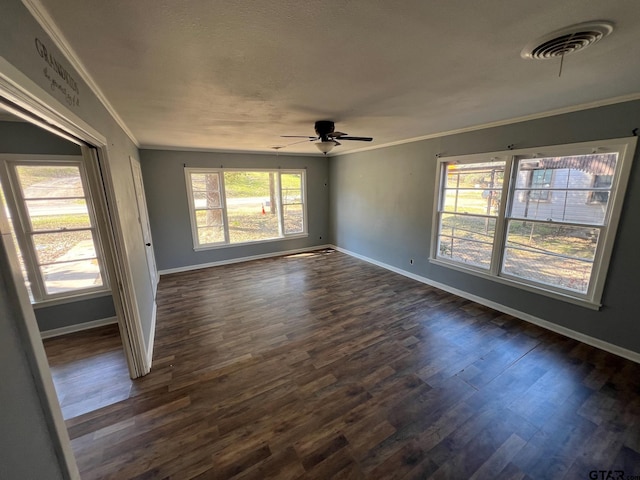 unfurnished room featuring baseboards, visible vents, ceiling fan, ornamental molding, and dark wood-style flooring