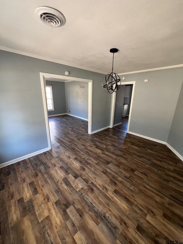 unfurnished dining area featuring dark wood-style floors, baseboards, visible vents, and crown molding