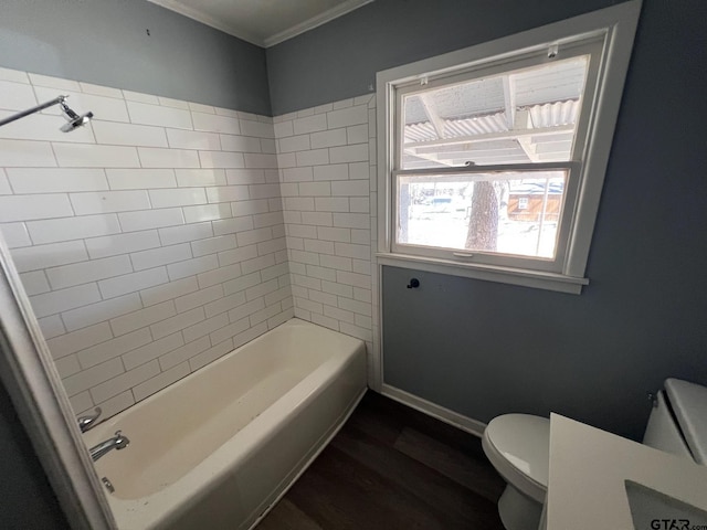 bathroom with baseboards, toilet, wood finished floors,  shower combination, and crown molding