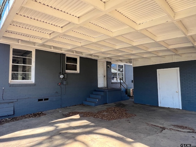 property entrance featuring crawl space and brick siding