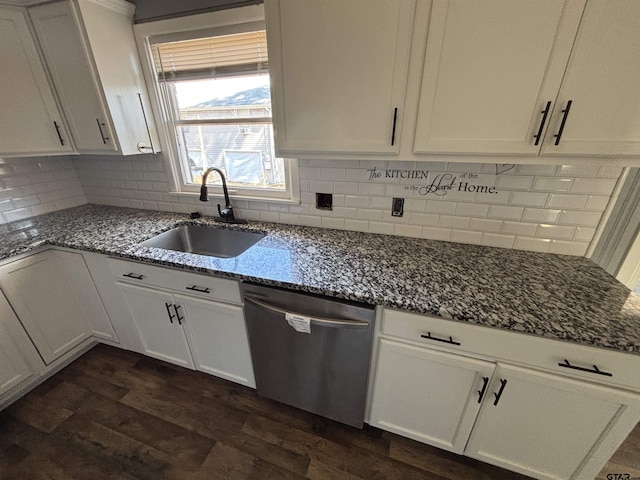 kitchen with a sink, white cabinets, dishwasher, tasteful backsplash, and dark stone countertops