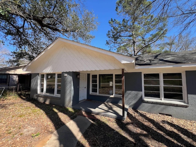 view of front of home featuring crawl space and brick siding